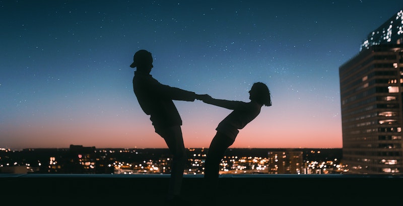 Couple holding hands on building