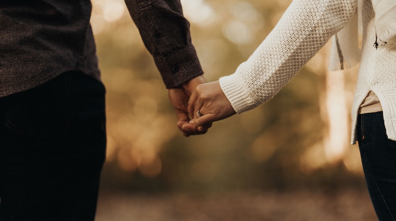 Couple Holding Hands After Money Fight