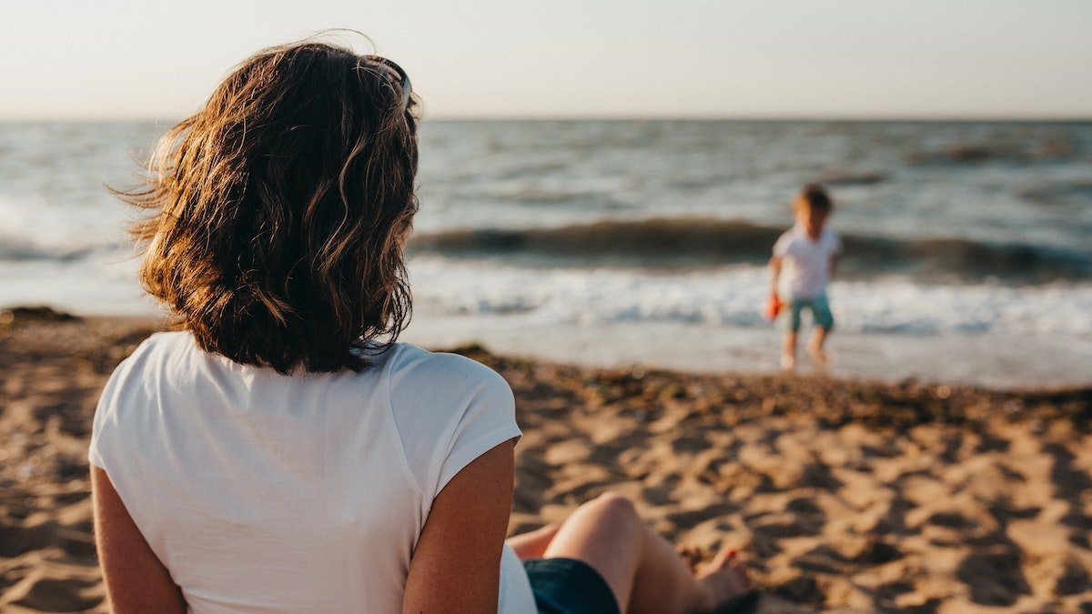 Mother watching son on beach