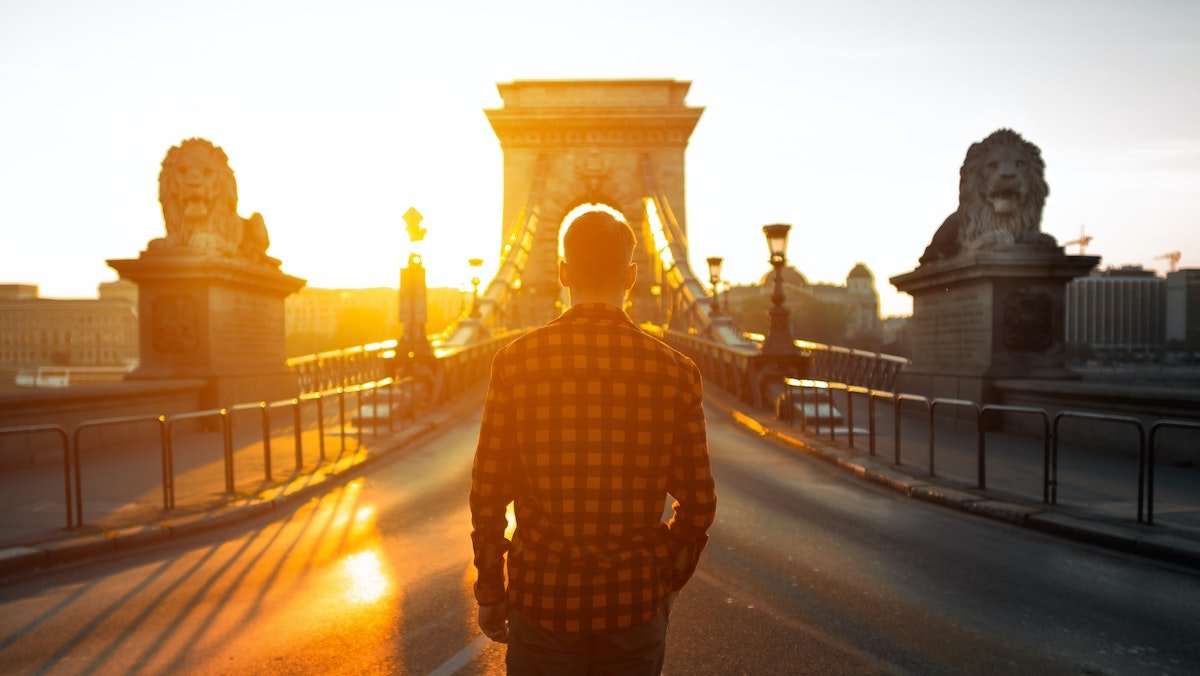 Man walking across bridge