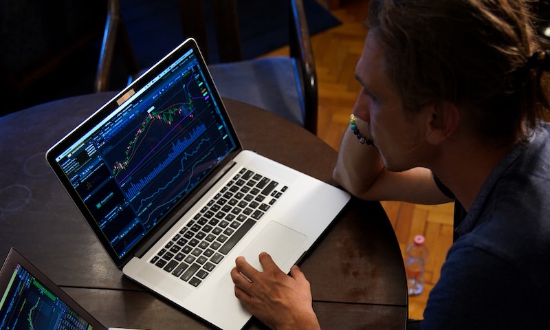 Stock market on laptop use investing to reach coast fire