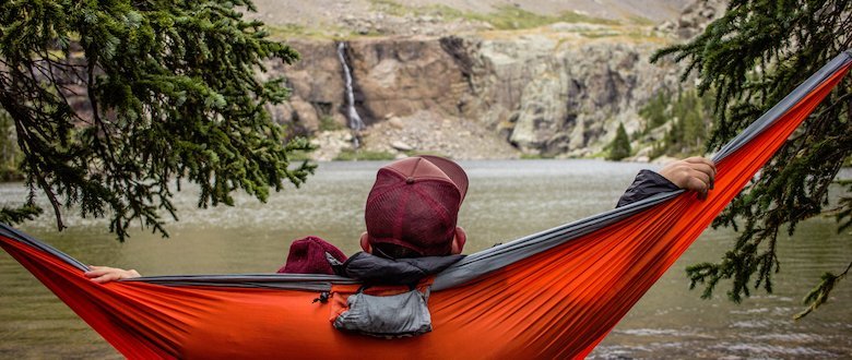 man relaxing in hammock