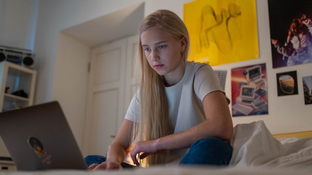 Teen working on laptop