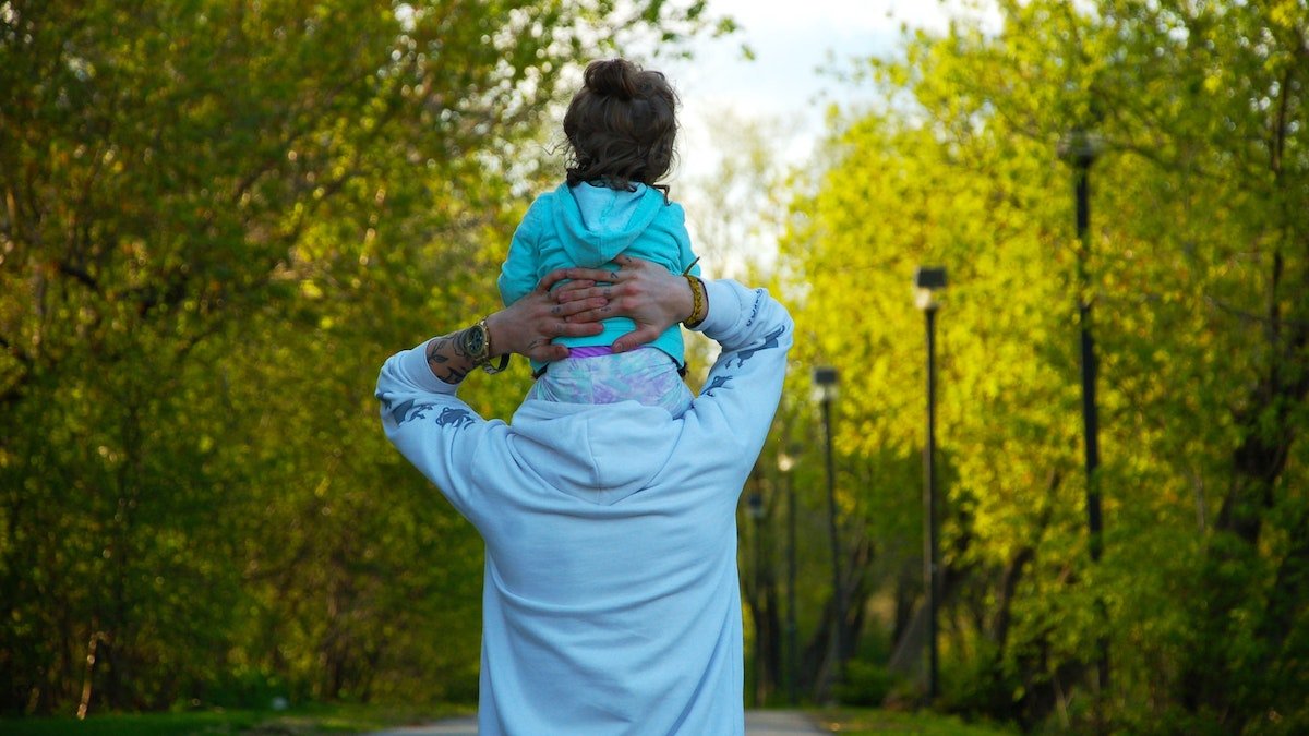 Daughter on Dad's shoulders