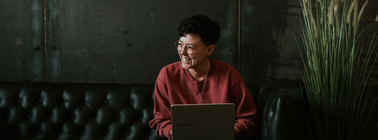 Woman on laptop smiling