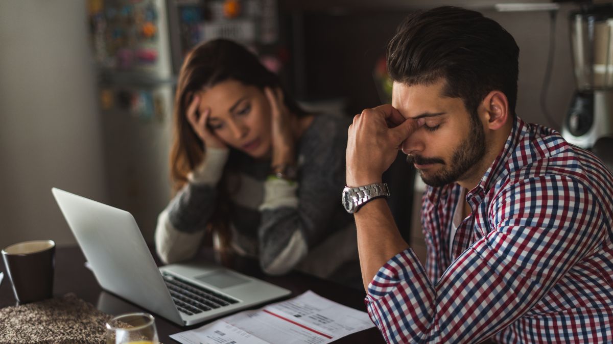 Worried couple at laptop