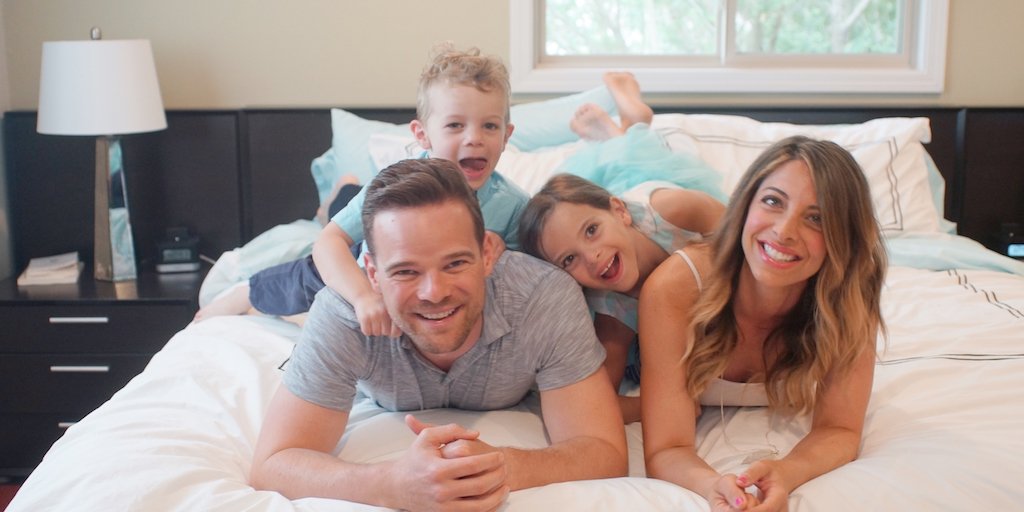 Andy, Nicole and the Hill Family on the bed